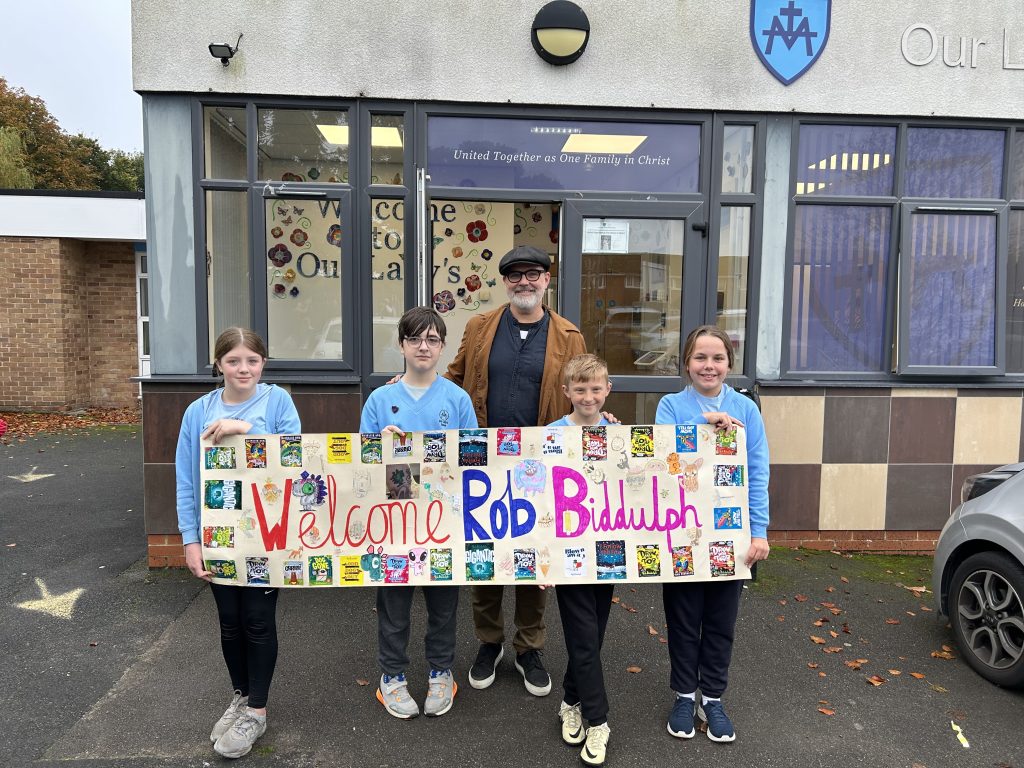 Children holding a welcome banner